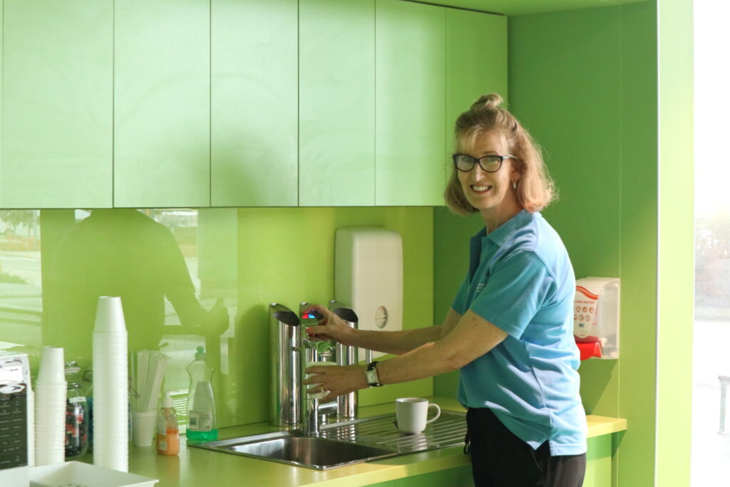 Photo of a RMHC WA Volunteer making a cuppa in the kitchen facilities of the Family Room at PCH