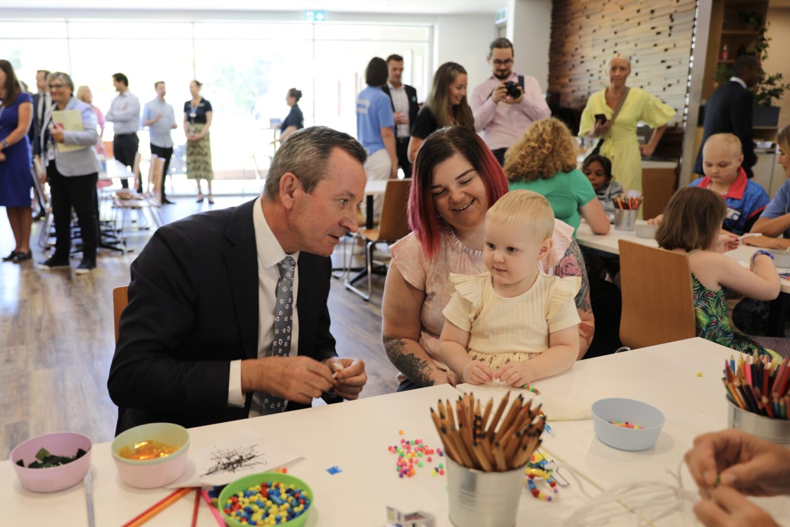 Premier of Western Australia Mark McGowan talks to child and mother at Ronald McDonald House Charities Western Australia