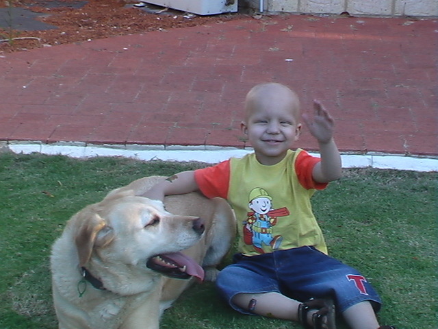 Ethan Lauro, smiling to camera with his dog