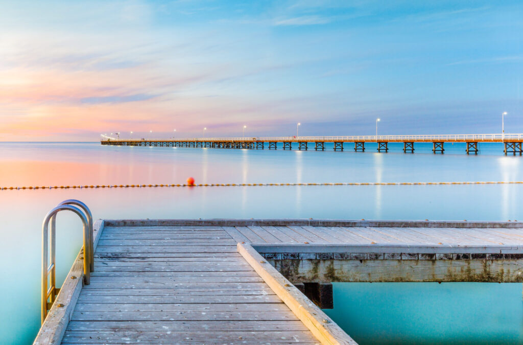 Photo of the swimming area at Busselton Beach with Busselton Jetty in the background