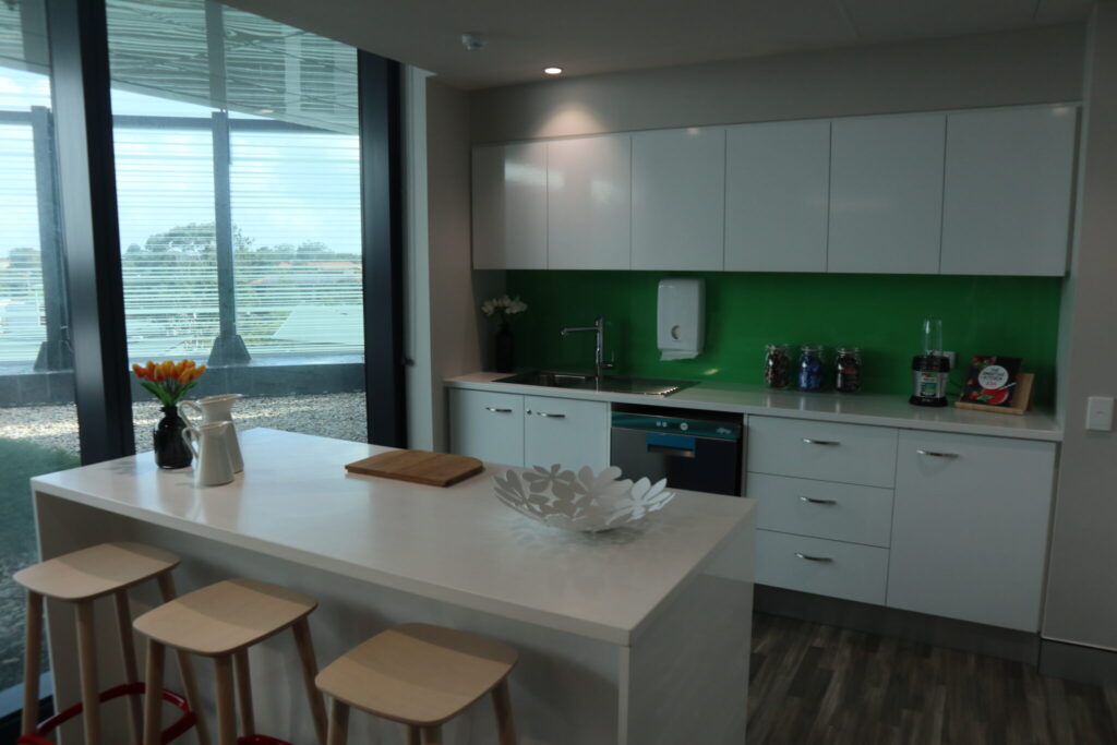 Photo of the kitchen area showing the kitchen island, counters and cooking appliances