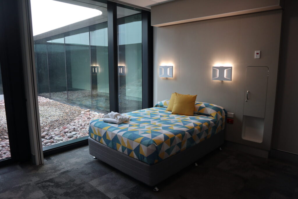 Photo of a bed in one of the ensuite rooms