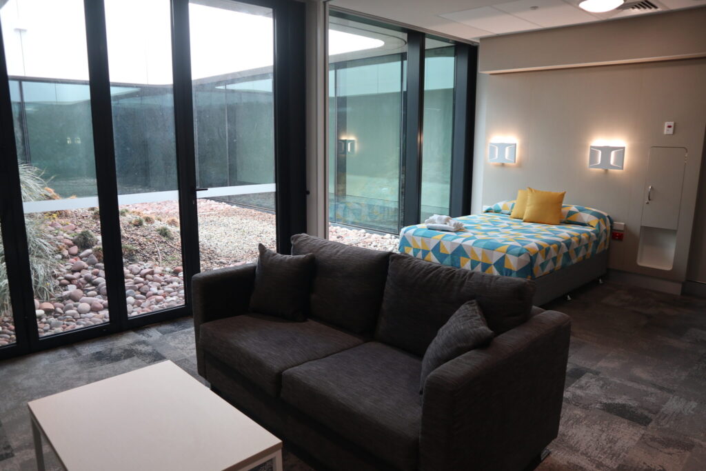 Photo of a lounge area and the bed in one of the larger ensuite rooms