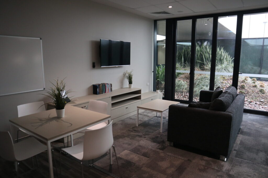 Photo of a lounge area and tv in one of the larger ensuite rooms