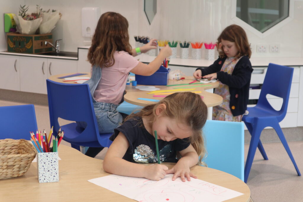 Photo of children doing arts and crafts in the Arts and Craft space