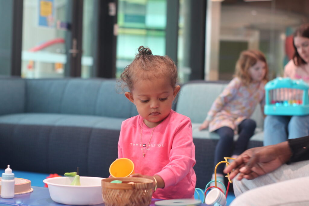 A photo of a toddler in the soft play area