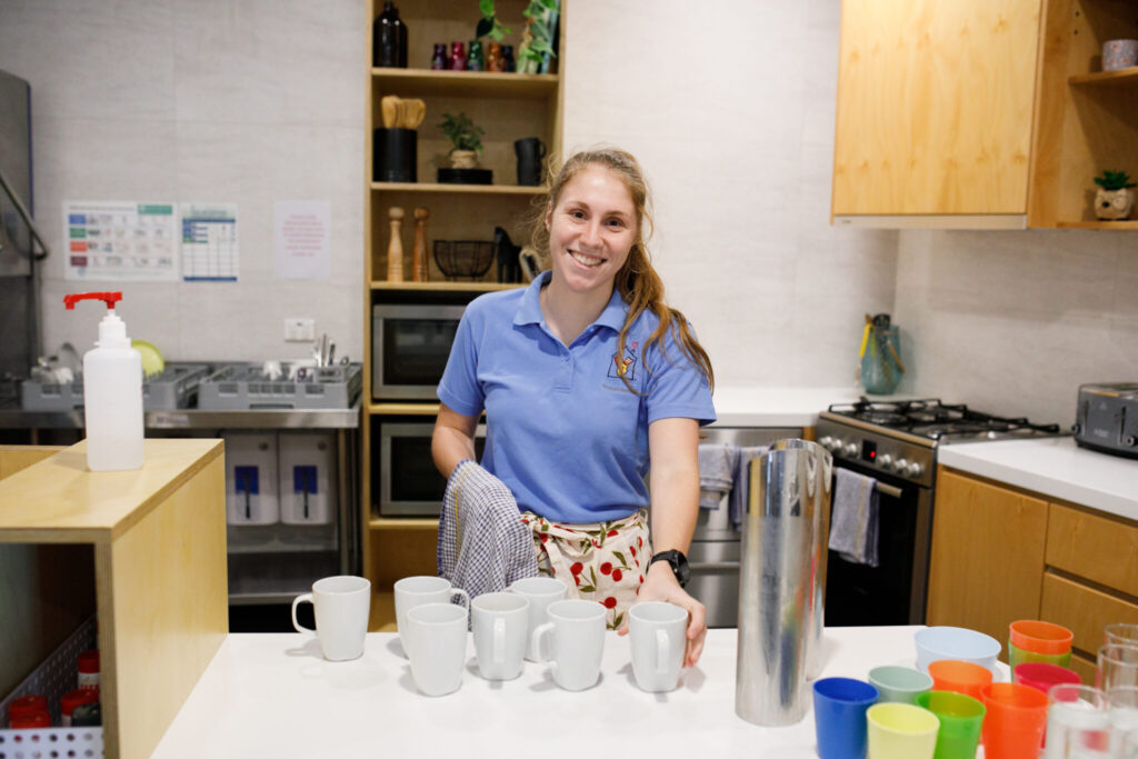 Photo of a volunteer in the domestic kitchen area of the Nedlands House