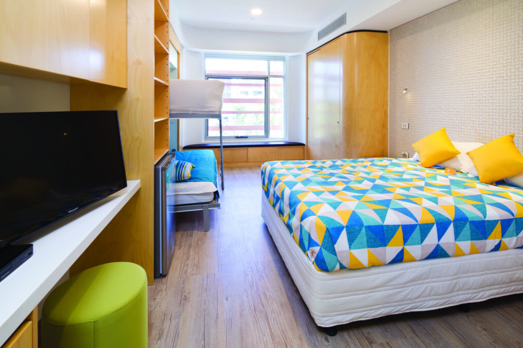 Photo of one of the ensuite rooms in the Nedlands house, showing 2 bunk beds set up along with a with a queen sized bed