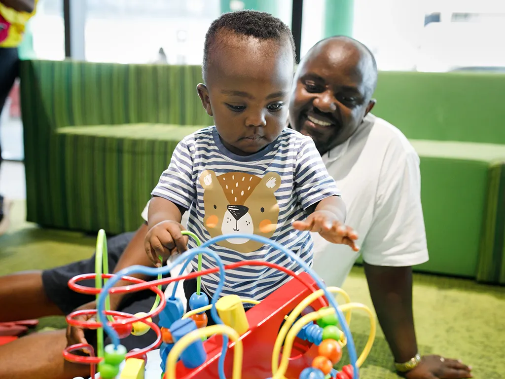 Image of Father and Son playing in Family Room