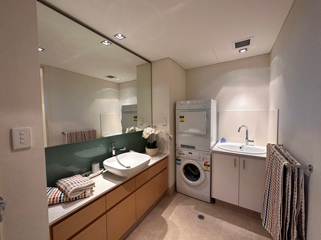 A photo of the bathroom and laundry in the Ronald McDonald Family Retreat in Mandurah, with a washer and a dryer
