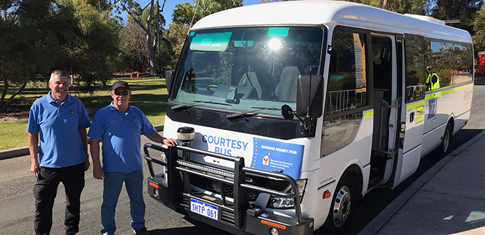 Volunteers in front of the courtesy bus they drive for Mellen Events
