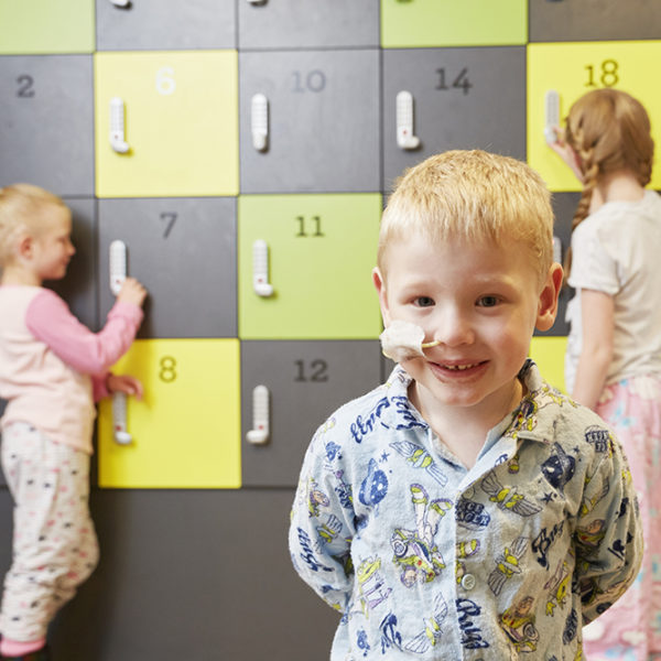 Photo of children standing in front of lockers