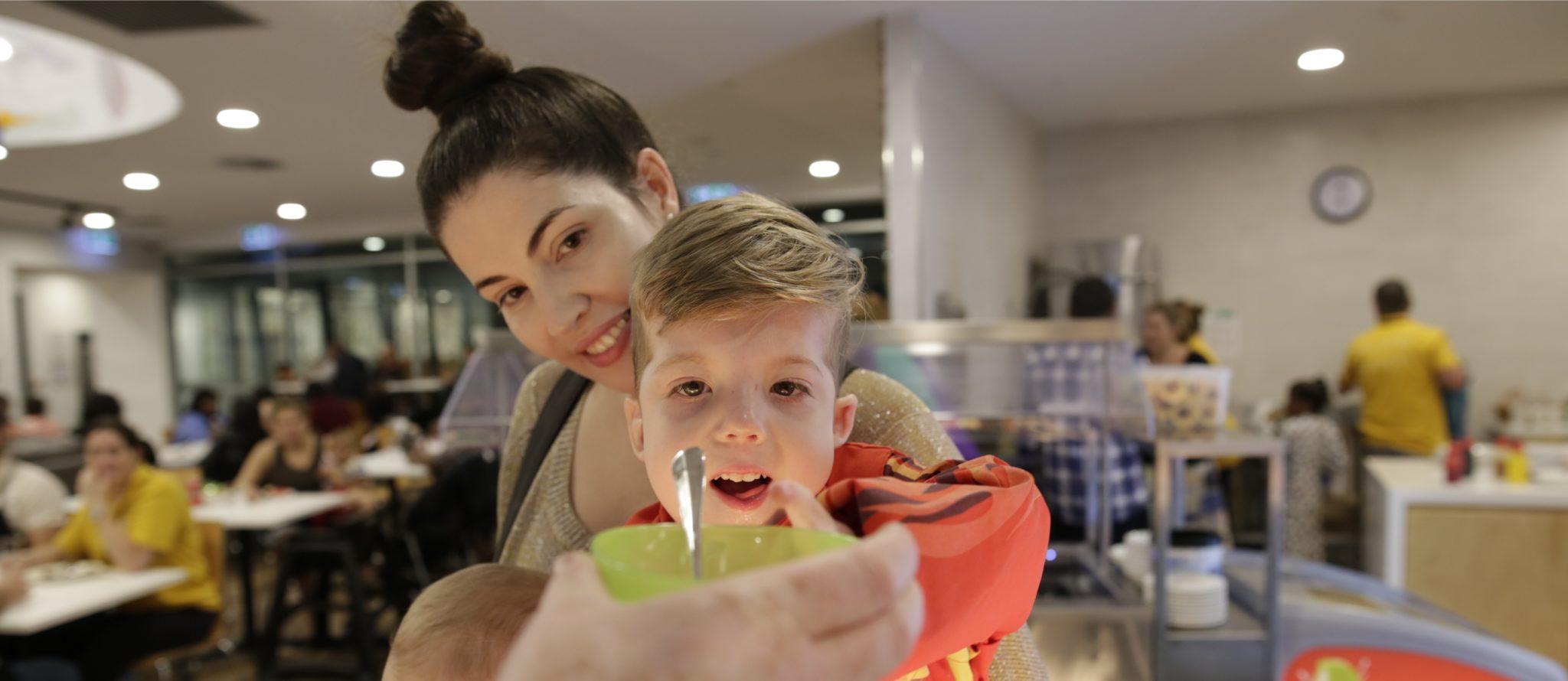 Photo of Teagan and Cobber being served a baked treat from Lovin from the Oven