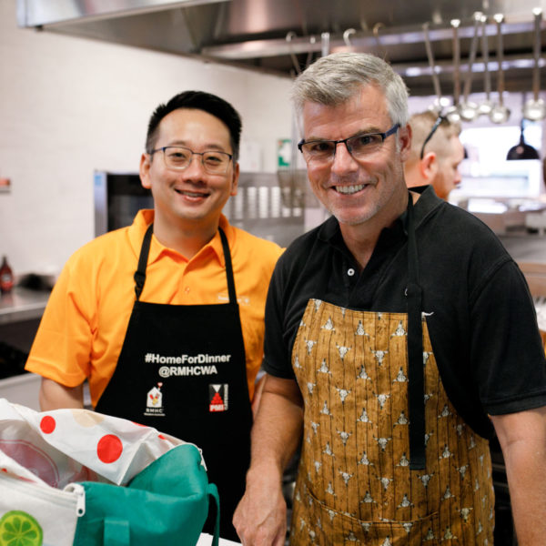 Photograph of 2 participants of the Home for Dinner program in the kitchen