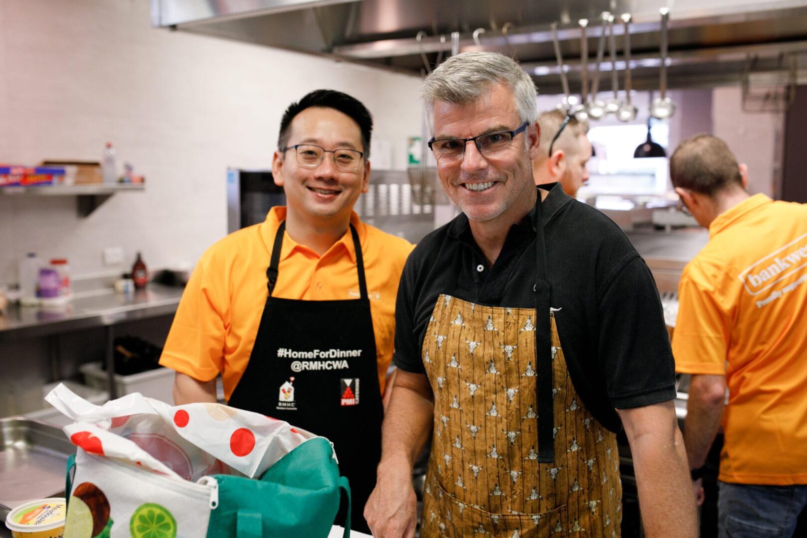 Photograph of 2 participants of the Home for Dinner program in the kitchen