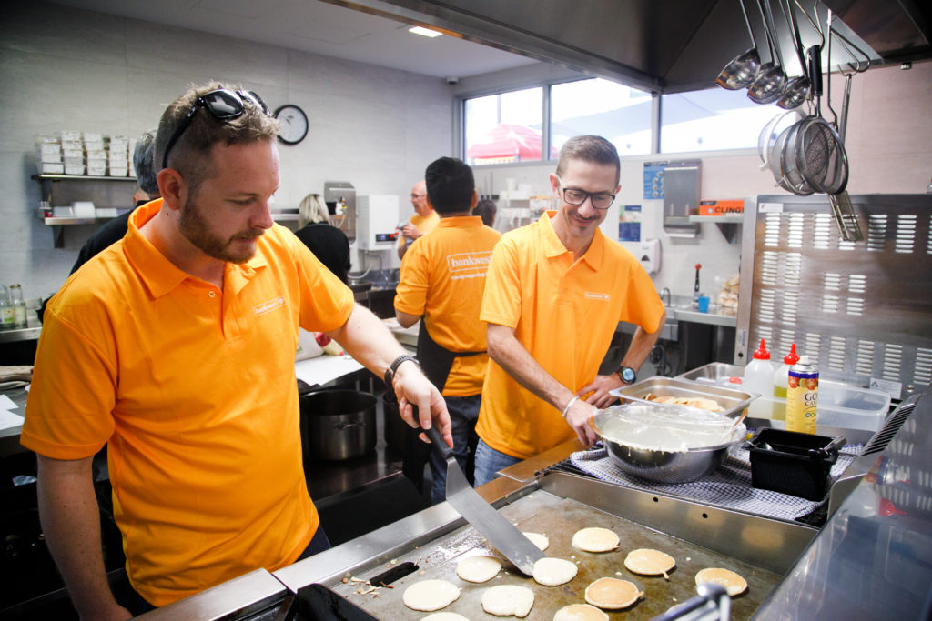 Replacement Image - The Big Breakfast Photo of team members cooking in the RMH Nedlands kitchen
